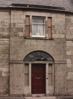 Detail of front entrance and first floor window.