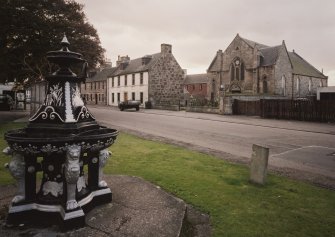 Ardesier Parish Church and 57 and 58 High Street. General view from NE showing late 19th century cast iron fountain