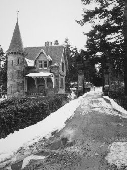 View of gatehouse, gates and bridge from north west