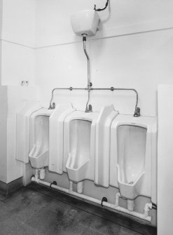 Interior. Ground floor, gents toilet, view of urinals from SW