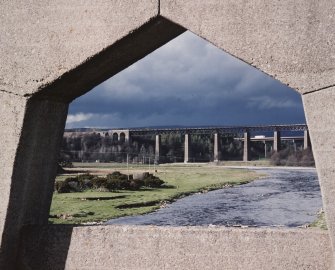 View of railway viaduct through parapet of road bridge