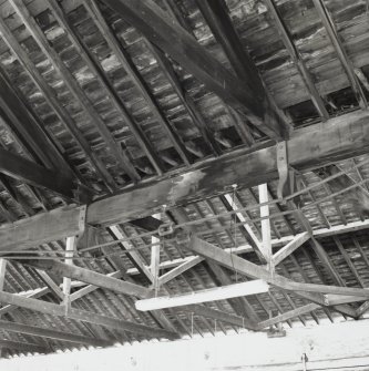 Detail of iron ties and cast-iron shoes beneath central wooden beam between 
2 bays of building