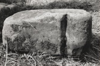 Side view of roll-moulded fragment at foot of Early Christian cross.
