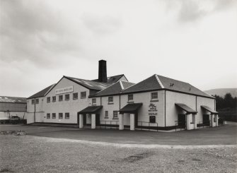 General view from SW of main block, including the two Tun Rooms, Mash House, Malt House and Boiler House chimney.