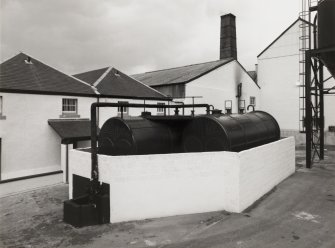 View from S of oil tanks (converted boilers), with  boilerhouse in background.