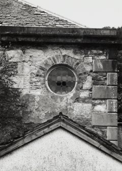 Detail of circular window in east wall of rear east wing