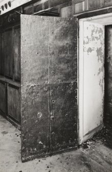Ground floor hall, view of door to east wing, east wing side, showing metal covering
