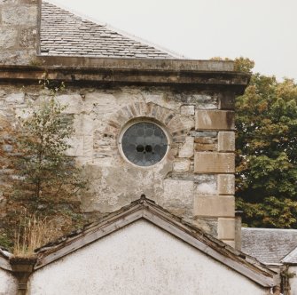 Detail of circular window in east wall of rear east wing