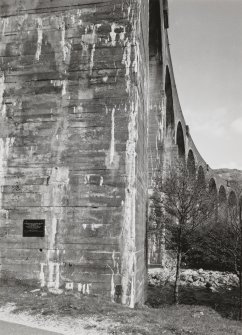 Glenfinnan Railway Viaduct over River Finnan
Oblique view from W of S side of viaduct, with typical concrete pier in foreground, and centenary plaque visible to left