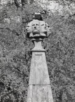 Detail of carved heads on top of monument