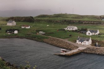 Muck, Port Mor and Pier Cottage. School, quay, cottage and gear store. View from WSW.