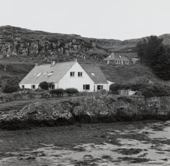 Muck, Port Mor. Port Mor House Hotel and building (NM 4208 7938) on terrace above. View from SE.