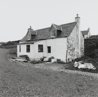Muck, Port Mor, Pier Cottage. Cottage and gear store. View from SSW.