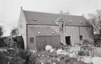 View of mill, showing the water wheel on its SW side.  The mill has been converted into a craft centre, but the water wheel has been retained in working order
