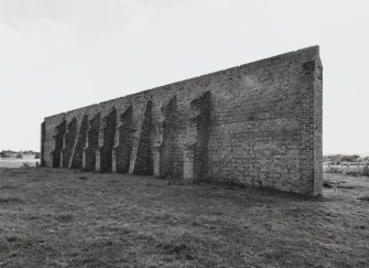 View.  from NW showing rear of wall with butresses.