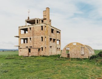 Fearn Airfield Naval Control Tower.  View from SE showing Nissen hut to rear.