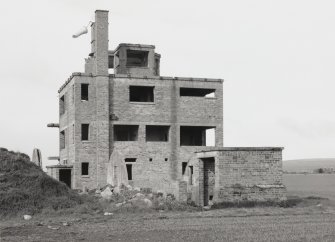 Fearn Airfield Naval Control Tower,  View from E showing remains of Nissen hut and toilet block to rear.