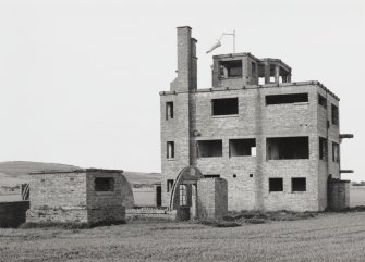 Fearn Airfield Naval Control Tower. View from NE showing remains of Nissen hut and toilet block to rear.