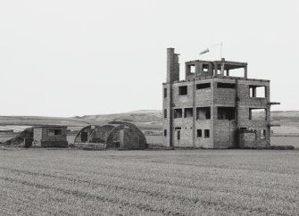 Fearn Airfield Naval Control Towe, view from N showing NW and rear elevations with Nissen hut and toilet block to rear.