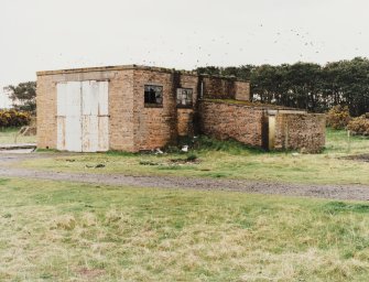 Fearn Airfield, Loans of Tullich accommodation camp.  View from NE of motor transport repair building and garage.  A small balst wall is visible on N wal of garage outshot.