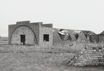 Fearn Airfield, Loans of Tullich accommodation camp.  The remains of the possible recreation block which was constructed from two large Nissen huts joined together in the centre by a brick built entrance block. View from NW which also shows part of an emergency blast shelter.
