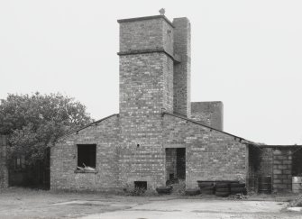 Fearn Airfield, Loans of Tullich accommodation camp.  The central catering and canteen block with tower for water tank and venting chimney.  View from NW showing front elevation.