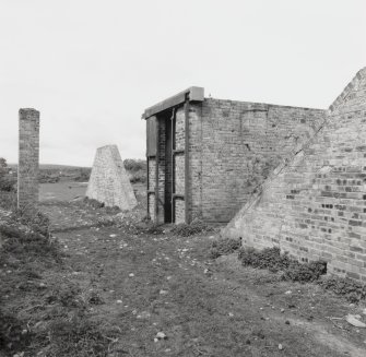 Fearn Airfield, view of bomb store on N side of the airfield.  View from ESE showing protected bomb store with the remaining upstanding blast walls after earth banks have been removed.