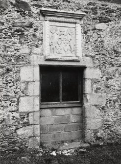 View of doorway (now window) with armorial panel above on south face of barn