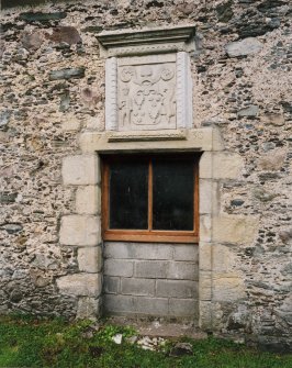 View of doorway (now window) with armorial panel above on south face of barn