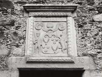 Detail of armorial panel and date lintel (1730) above doorway on south face of barn