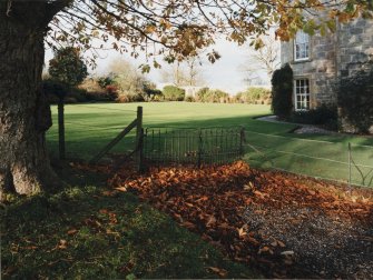 Detail of gate adjacent West wing of Geanies House with view of West garden beyond