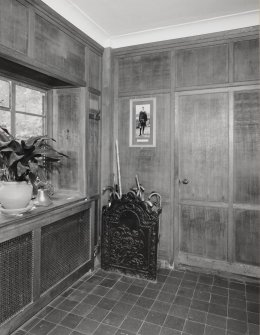 Interior. View of panelled entrance hall with fireback umbrella stand