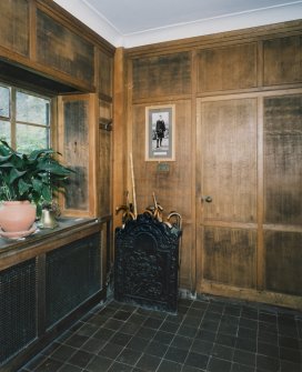 Interior. View of panelled entrance hall with fireback umbrella stand