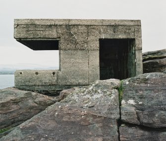 View from NW of searchlight emplacement showing entrance and foundation on bedrock