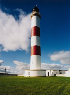 View from E, showing tower and buildings at its base