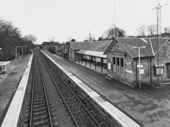 View from NW (from footbridge) showing station building and platforms