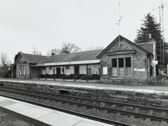 View from N of NE side of station building, facing the N-bound platform