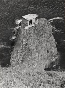 View from SW over cliffs to searchlight emplacement on rock stack.  Also visible are sections of timber access steps.