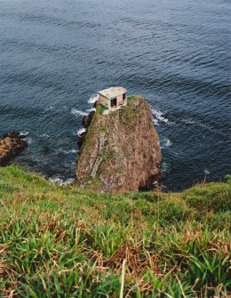 General view from SW over cliffs to searchlight emplacement on rock stack.  Also visible are sections of timber access steps.