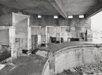 Interior view from S showing part of the gun pit and rear wall including some of the ready-use ammunition lockers.