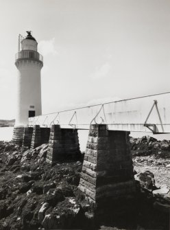 Skye, Eilean Ban, Kyleakin Lighthouse.
View of lighthouse from E-N-E, showing iron and wood walkway, carried on battered rubble piers across the rocky foreshore.