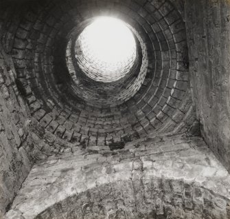 Detailed interior view looking up the column/chimney of the kiln, showing its fireclay brick lining.  The bricks were manufactured by Star Works (Glenboig, Lanarkshire) and Etna Works (Armadale, West Lothian).