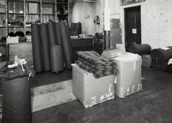 Warehouse (building 4): View of finished goods, including rolls of cloth (centre) and folded cloth (right) [the building numbers in brackets refer to the itemised plan, D33088]