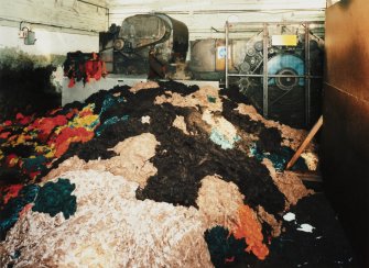 Teazing Department (building 42): view of larger of two teazing machine, with wool (foreground) ready to be loaded [the building numbers in brackets refer to the itemised plan, D33088]