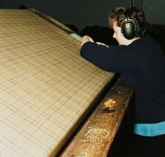 New Weaving Flat: detail of Sheila Sutherland at one of the six Vamatex loom's darning tables