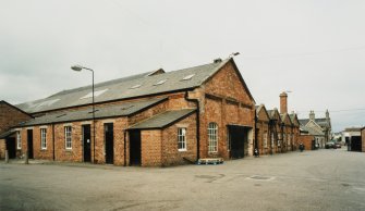 View from WSW of S side of central block of works, including (left to right) former Canteen (building 11), Old Loom Flat (now a wool store, building 10), 'Warehouse' (building 4), Offices (buildings 2 and 3), and (far right) Gatehouse (building 1) [the building numbers in brackets refer to the itemised plan, D33088]