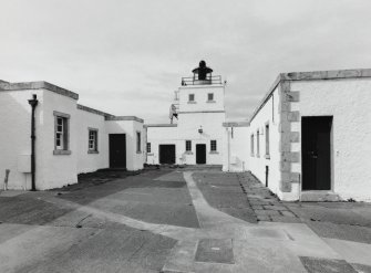 View from S showing light tower and accommodation buildings.