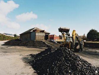 View from SW of former goods station building, being used by a coal merchant