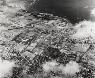 RAF WWII oblique aerial photograph of Edinburgh, North West taken from the SE.  Visible are the Royal Botanic Gardens, Fettes College, part of the New Town, the Colonies and the districts of Pilton and Granton.
Print in record