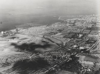 RAF WWII oblique aerial photograph of N and NW Edinburgh from the SW.In the foreground, Blackhall district and Craigleith Quarry with Granton, Granton Harbour middle distance and Leith in the far distance.